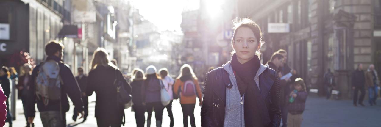 My Life With an Invisible Disability woman walking outside on a busy city street