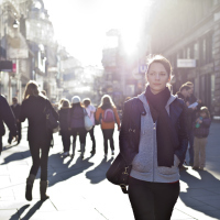 woman walking outside on a busy city street