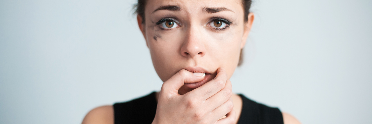 How I Explain Anxiety When People Don't Understand It The upset woman bites one's nails.