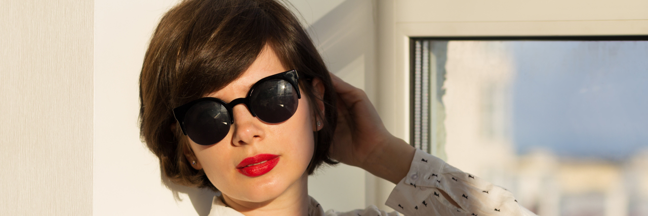 Acceptance: The Goal I Want Us All to Reach on World Autism Day 2018 Girl with sunglasses daydreaming sitting by the window