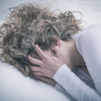 close up of young woman crying in despair covering face