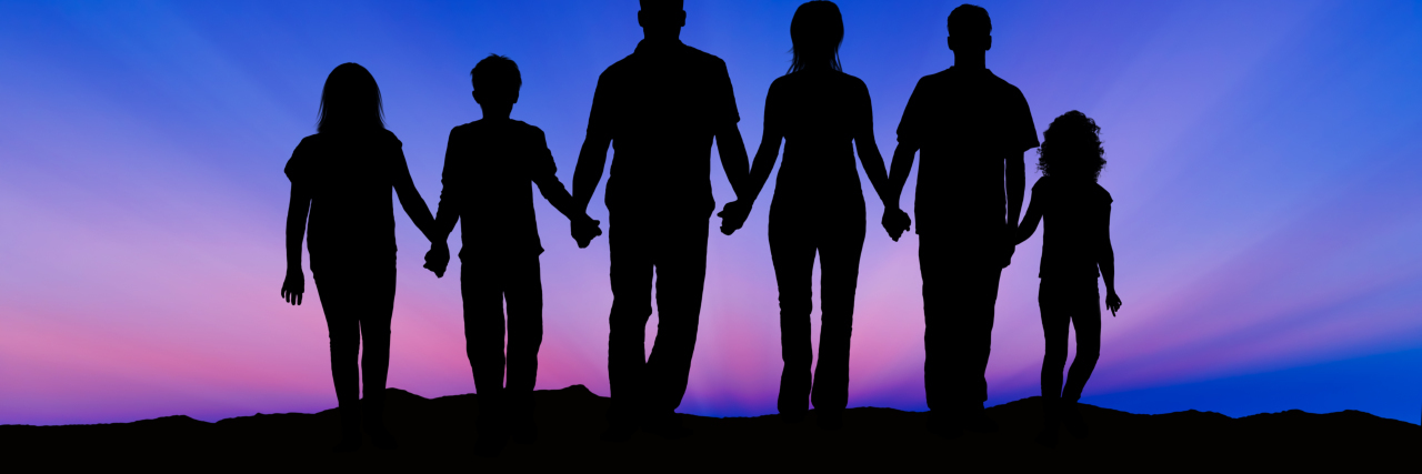 Raising Awareness on Stiff-Person Syndrome Awareness Day Silhouette of a family comprising a father, mother and children walking into the sunset