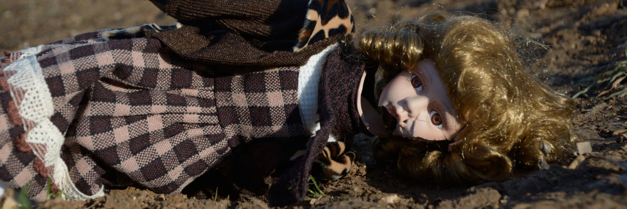 How I Learned to Treasure the Broken Porcelain of My Mental Health broken porcelain doll lying on ground abandoned