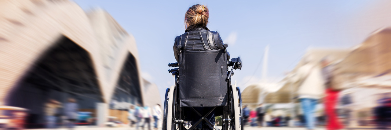 Why I Chose to Use a Wheelchair for ME/CFS young lady in a wheelchair looking for a destination
