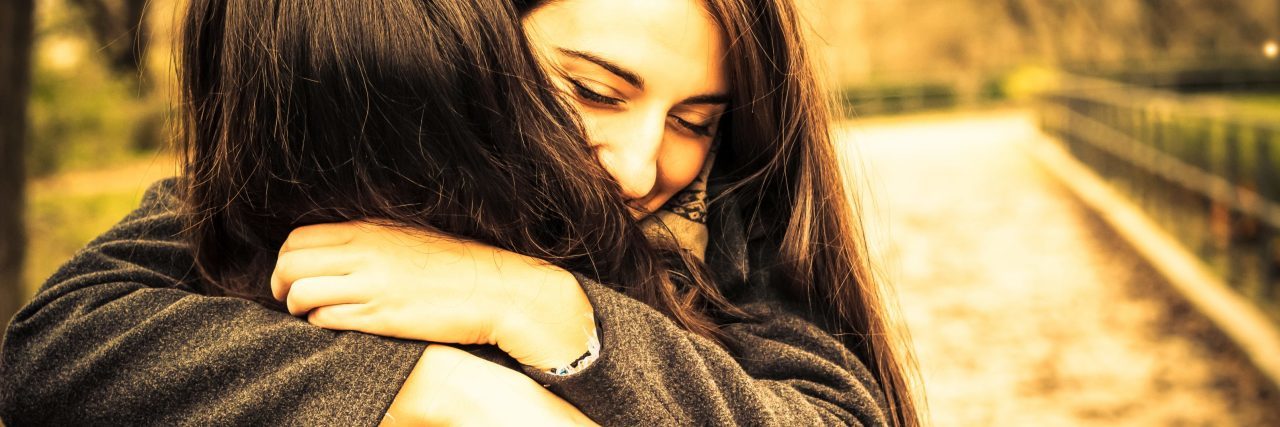 When Depression Makes You Question If Life Is Worth Living, Read This two women hugging in park in s