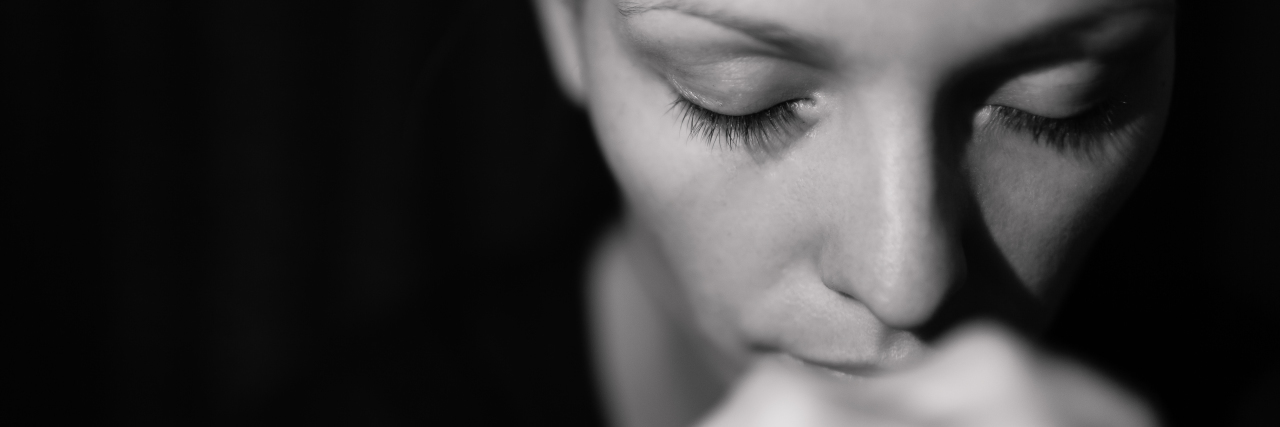 Feeling Isolated When Parenting a Child With Alexander Disease Portrait of young woman praying.