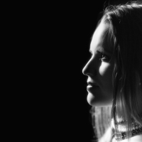 profile of young sensual woman on black background monochrome image