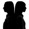 Silhouette of women standing back to back on white background