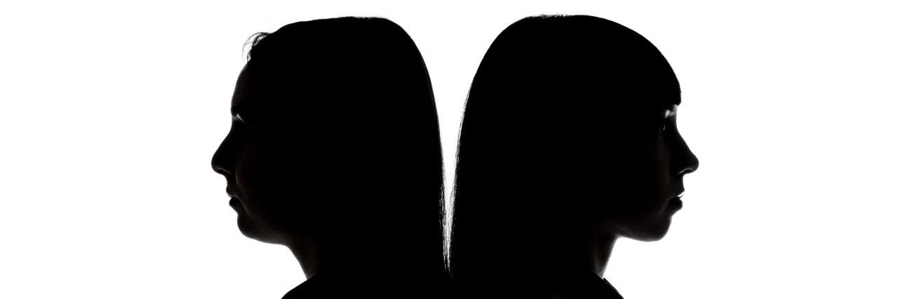 Silhouette of women standing back to back on white background