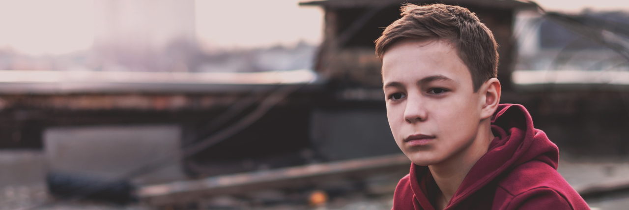 Things People Don't Realize You're Doing Because You Had Abusive Dad Lonely teenager sitting on roof the house