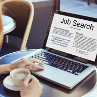 Woman searching for a job on the computer.