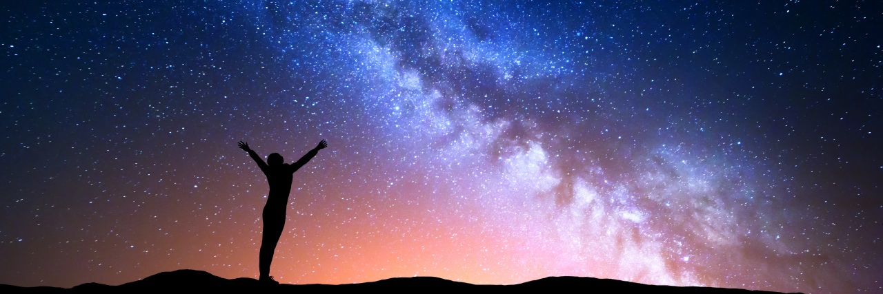 Reaching for the Stars With Autism Woman reaching for the stars.