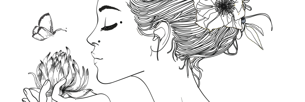 Learning to Love Myself With Fibromyalgia black and white image of a woman holding a flower and smelling it