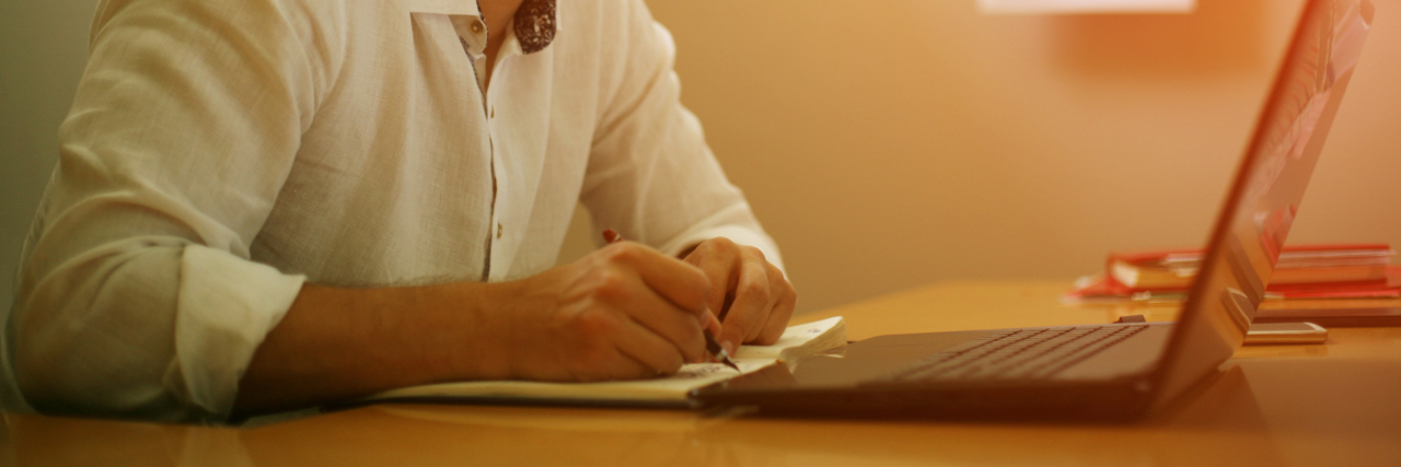 Receiving Help From an Advocate at Cigna With a Rare Disease Young designer working on laptop at his home office.