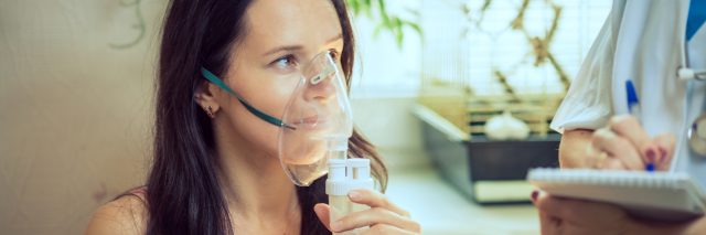 Girl with breathing problems using a nebulizer