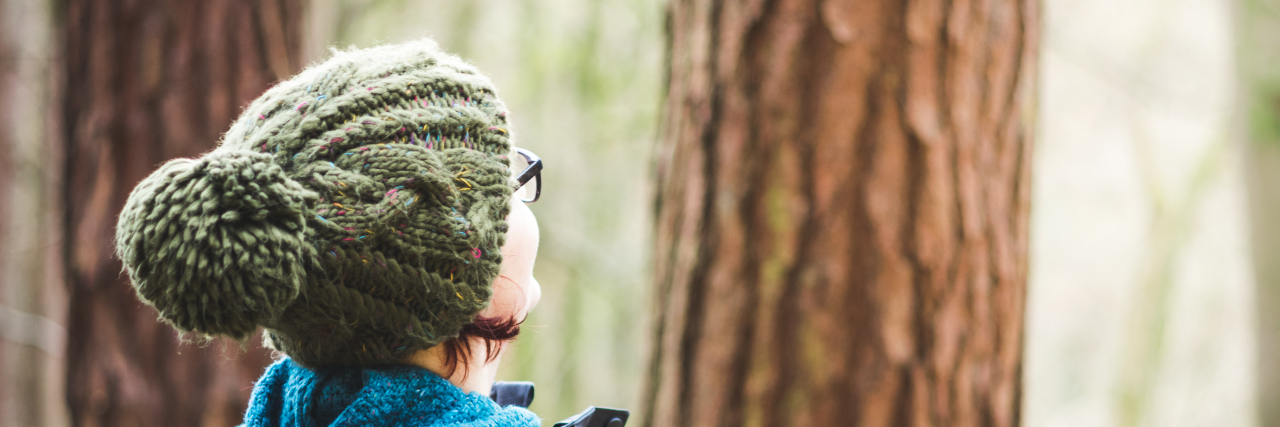 Woman in winter woodland.