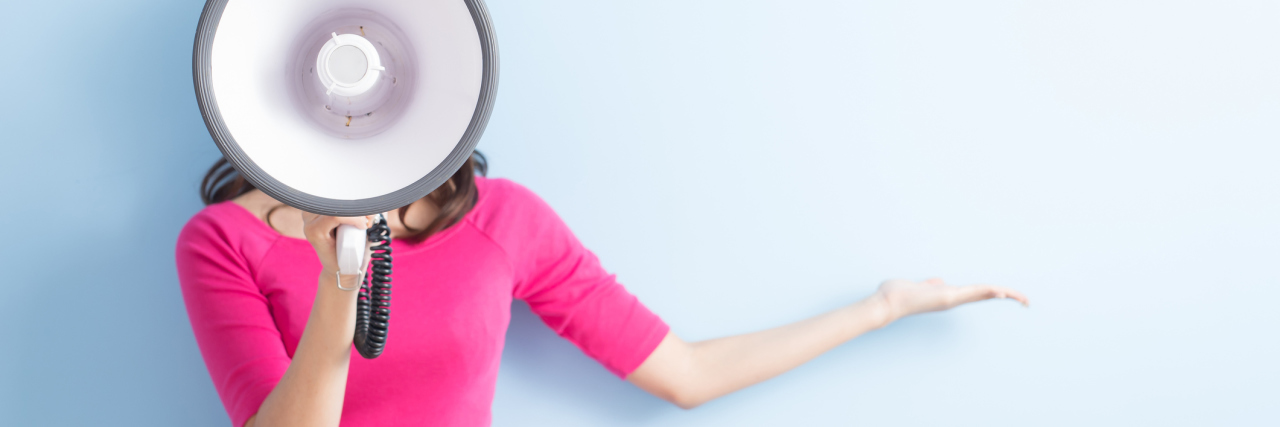 How to Raise Awareness During Endometriosis Awareness Month woman in a pink shirt holding up a megaphone