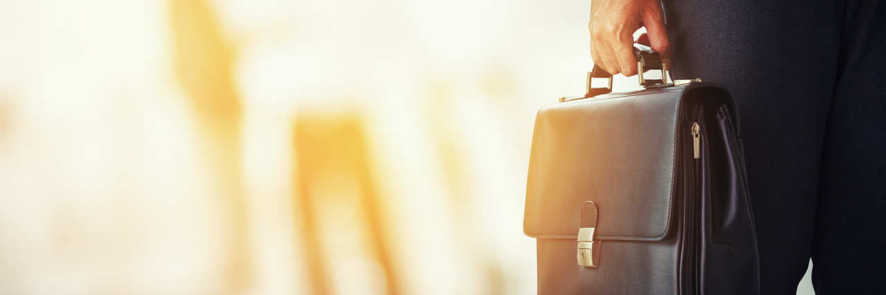 My Journey From Autism to Special Education Attorney Lawyer holding his briefcase.