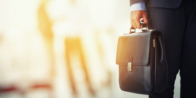 My Journey From Autism to Special Education Attorney Lawyer holding his briefcase.