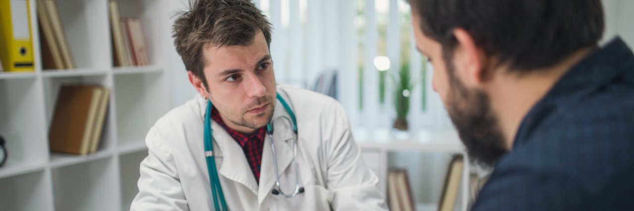 young doctor talking with a male patient