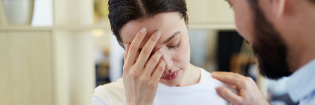 When You're 'Rude' to Coworkers Because You Have a Headache man talking to woman with a headache