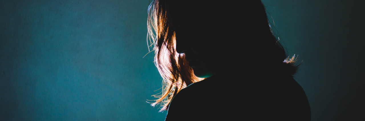 What It Was Like to Be Diagnosed With Crohn's Disease silhouette of a woman standing with her back turned to the camera