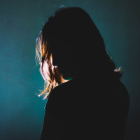 silhouette of a woman standing with her back turned to the camera
