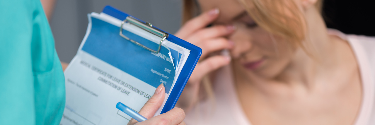 When Doctors Only See My Mental Illness Cropped shot of nurse holding clipboard and pen while upset patient sitting behind