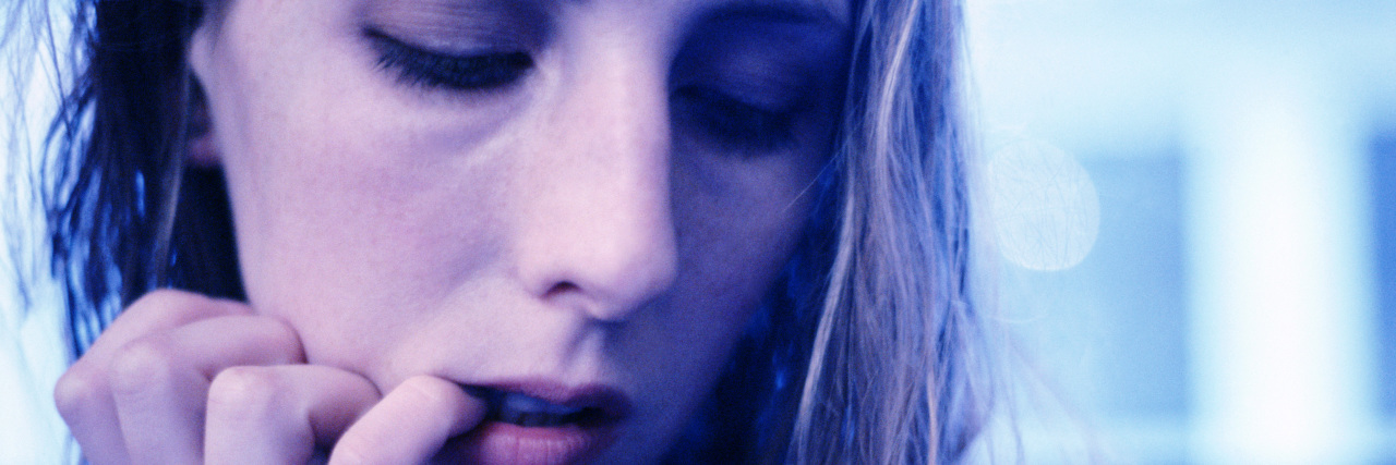 The 'Bad Habit' That Turned Out to Be Dermatillomania Woman biting finger