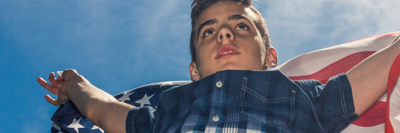 Why America Needs to Talk About Mental Health and Guns A young boy holding the american flag