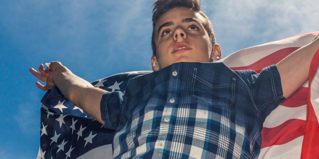 A young boy holding the american flag