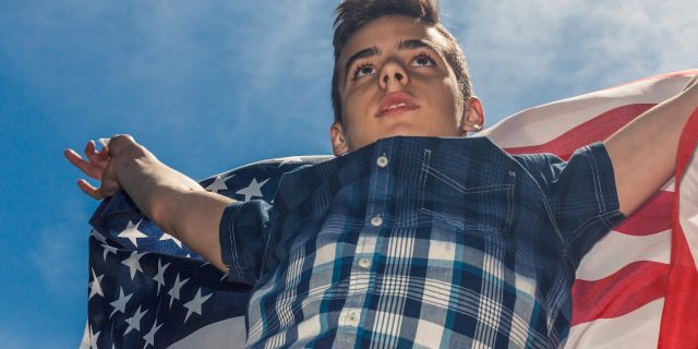Americans Shouldn't Have to Choose Between Gun Reform and Mental Health Policy A young boy holding the american flag