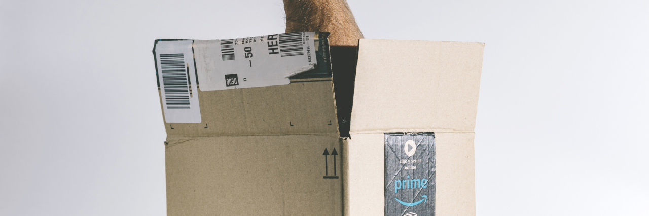 man's hand reaching inside amazon prime box