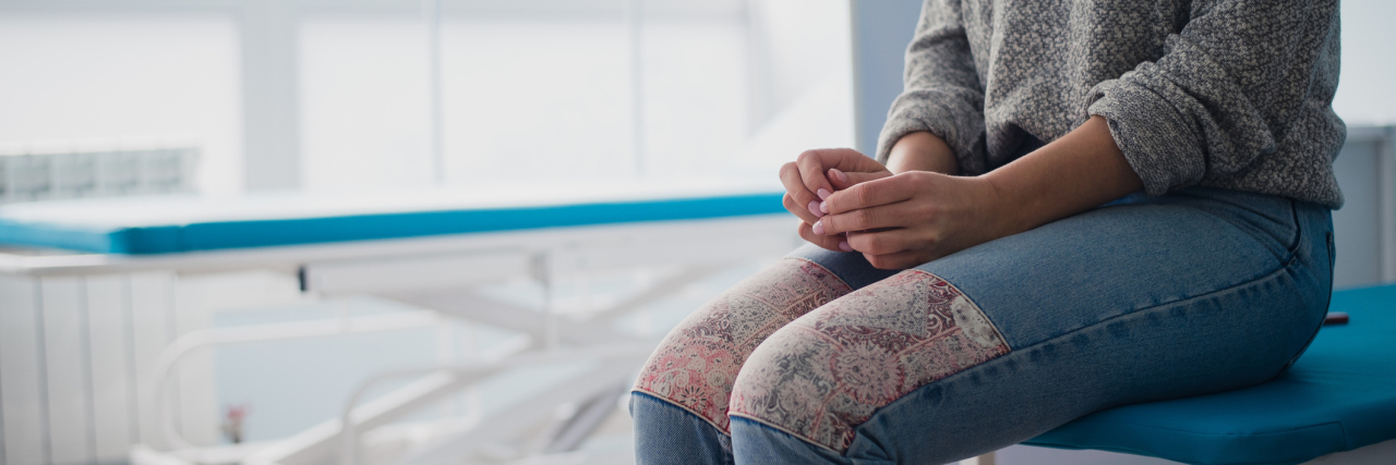 Gender Bias and Discrimination Against Women in Healthcare woman sitting on a hospital bed