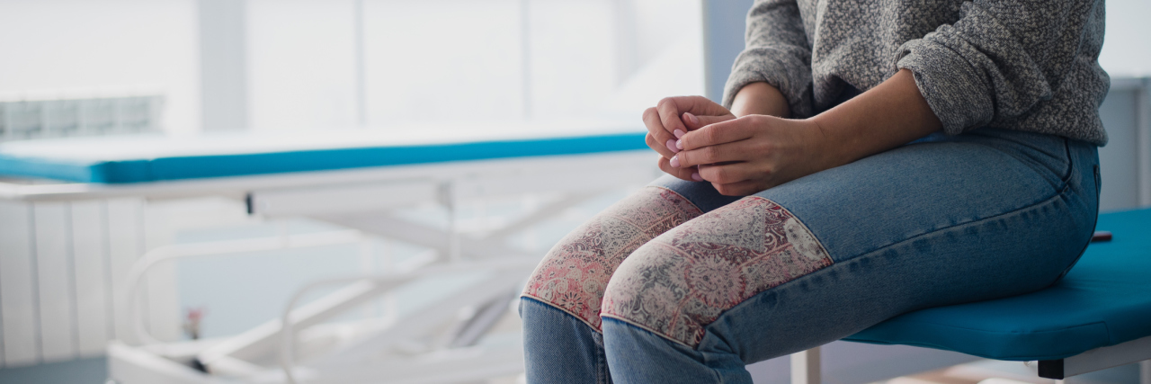 What to Expect During a Psychiatric Hospital Admission woman sitting on hospital bed anxiously awaiting doctor