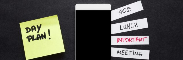 Smartphone with paper list of reminders.