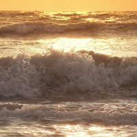 Rough waves with view of sunset.
