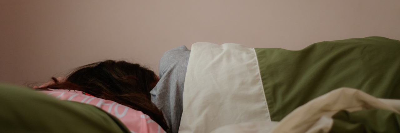 5 Moments That Show What a Fibromyalgia Flare Is Like Young woman is sleeping from the back in bed