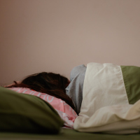 Young woman is sleeping from the back in bed