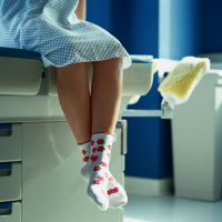 woman sitting on an exam table in a doctor's office