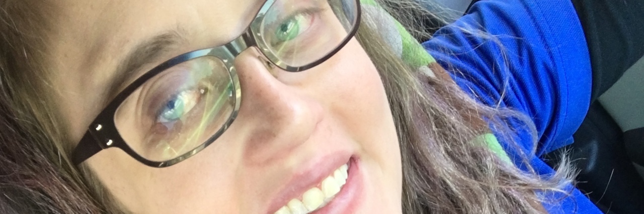 Resigning From My Job Because of My Congenital Heart Disease woman wearing a blue shirt and glasses and taking a selfie on her last day of work