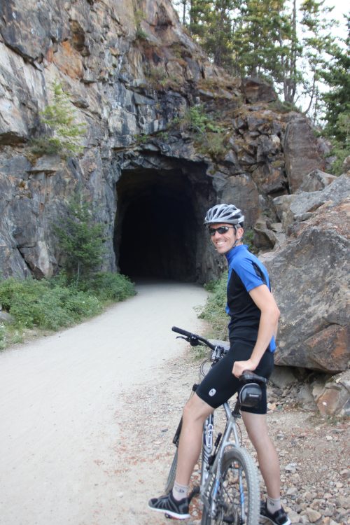 man riding bike on path