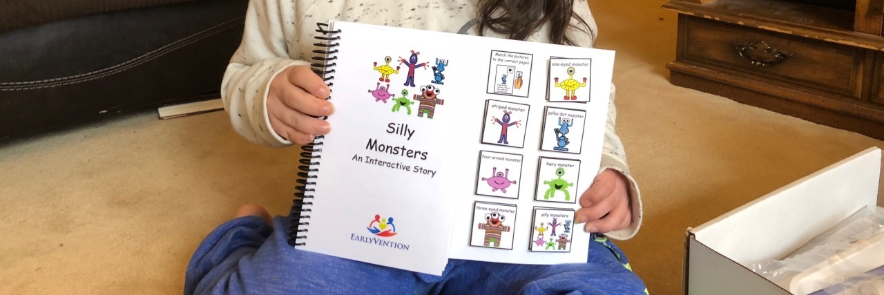 Review of EarlyVention Subscription Kits for Kids With Disabilities Girl showing EarlyVention book