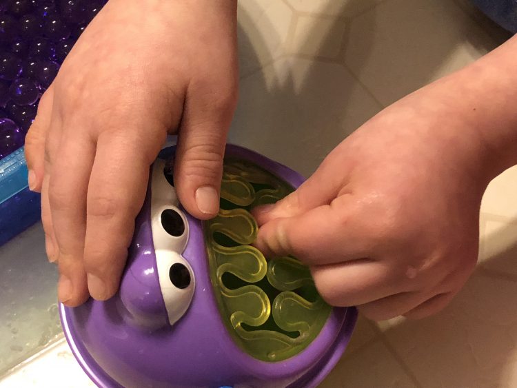 Fine motor skills practice, beads in monster mouth