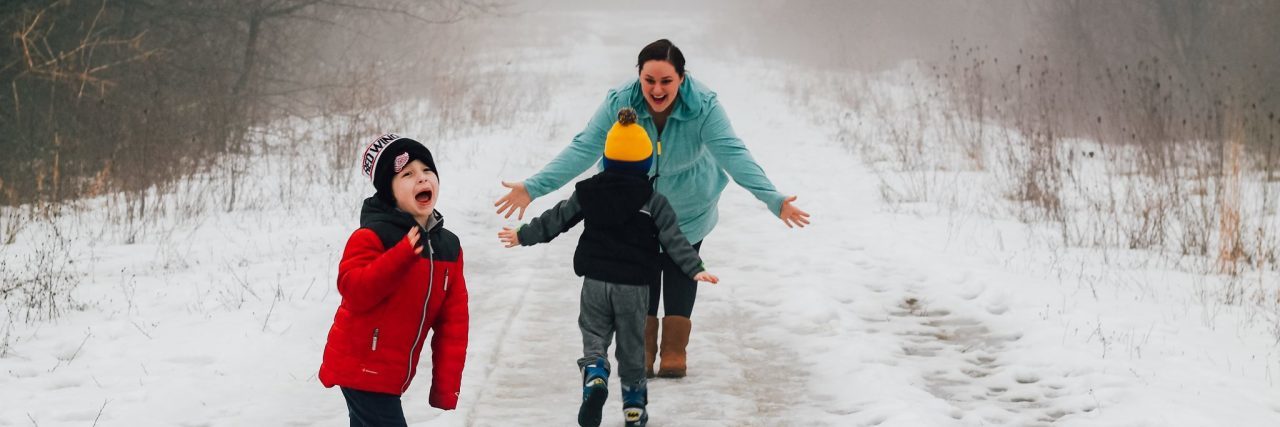 How I Explain Endometriosis to My Young Kids boys playing in the snow with mom