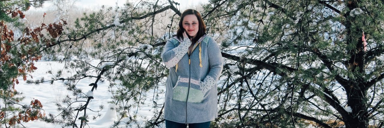 My Hysterectomy for Endometriosis Means I Can't Have Another Baby woman in a blue jacket standing outside in the snow