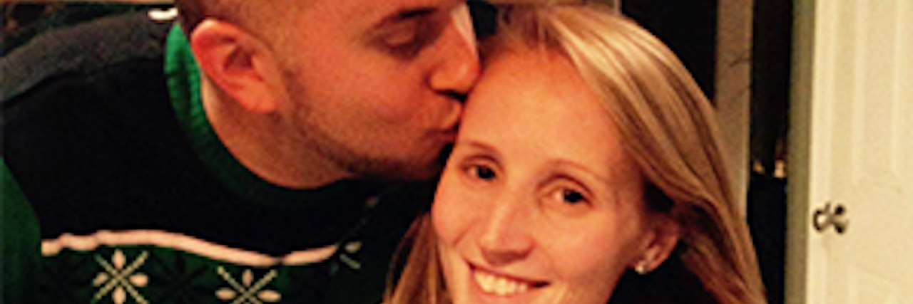 Finding Support After Spouse Died From Cystic Fibrosis husband kissing wife on the forehead