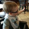 Little boy with Down syndrome looking at cow toy at Chick-Fil-A