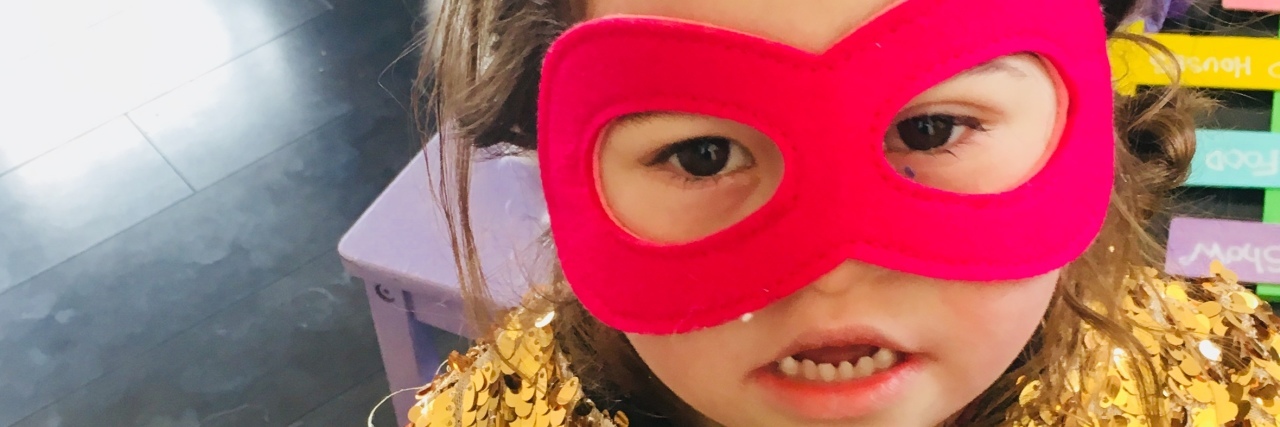 Girl with Down syndrome wearing a mask