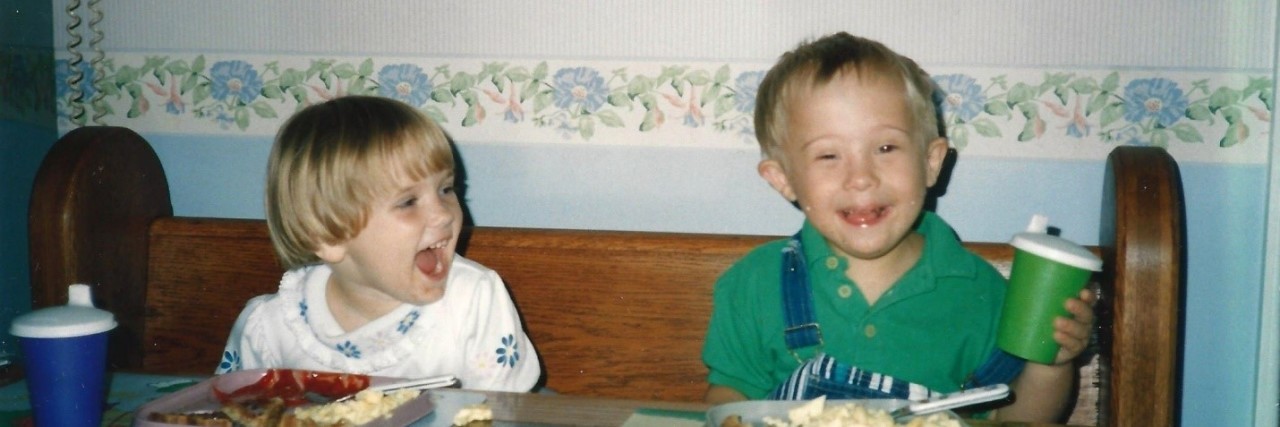 My Brother With Down Syndrome Also Has Invisible Disabilities Brother and sister sitting at kitchen table